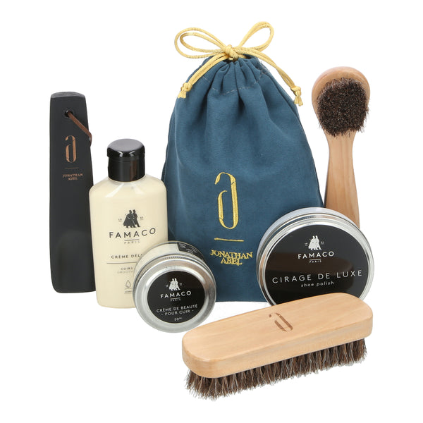 Shoe care starter kit with Famaco cream, cleaner, wax polish, brushes, and shoe horn. Nourishes, cleans, and shines leather shoes with ease.