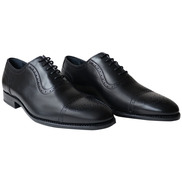 Black Oxford shoes with brogue cap-toe design in full-grain leather, Goodyear welted and handcrafted in Portugal for classic, elegant style.