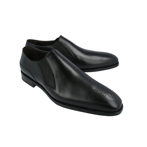 Black loafer shoes with medallion toe and side elastics in full-grain leather, Goodyear welted and handcrafted in Portugal for formal comfort