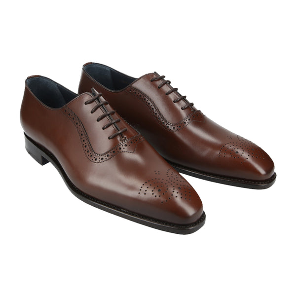 Chocolate brown Oxford shoes with elegant brogue detailing in full-grain leather, Goodyear welted and handcrafted in Portugal with a chisel last.