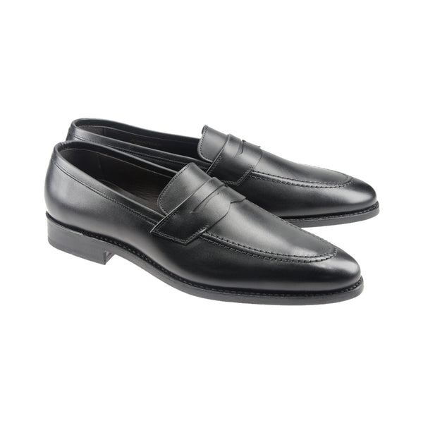Black penny loafers in full-grain leather with round toe and Goodyear welt, handcrafted in Portugal for flexible comfort and sleek style.