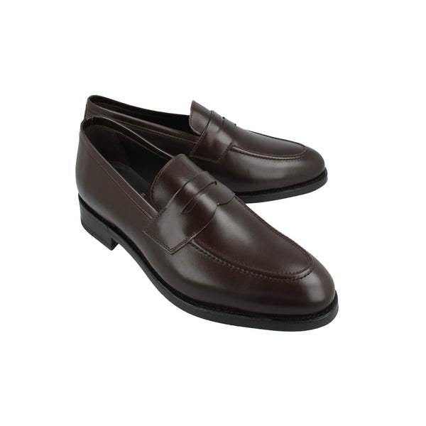 Walnut brown penny loafers in full-grain Italian leather with Goodyear welt, handcrafted in Portugal for timeless comfort and versatility.