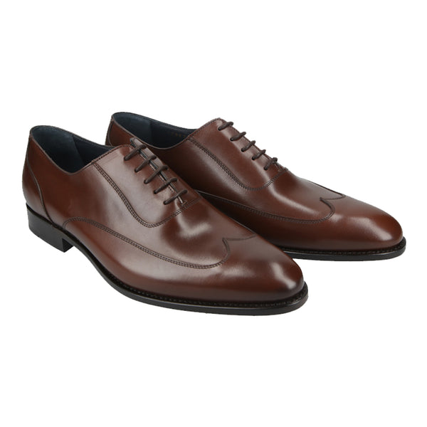 Chocolate brown Oxford shoes with curved cap-toe detail in full-grain leather, Goodyear welted and handcrafted in Portugal for refined style.