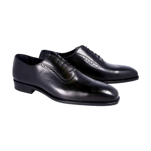 Black Oxford shoes with subtle brogue detailing in full-grain Italian leather, Goodyear welted and handcrafted in Portugal with a chisel toe.