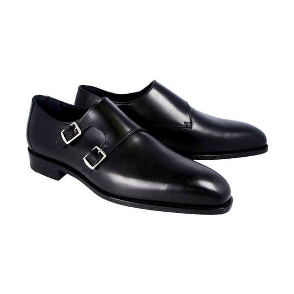 Black double monk strap shoes in full-grain Italian leather with sleek chisel toe, Goodyear welted and handcrafted in Portugal for timeless style