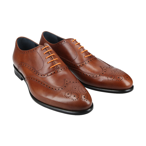 Tan leather wingtip Oxford shoes with brogue detailing and Goodyear welt, handcrafted in Portugal for classic elegance and durable comfort.