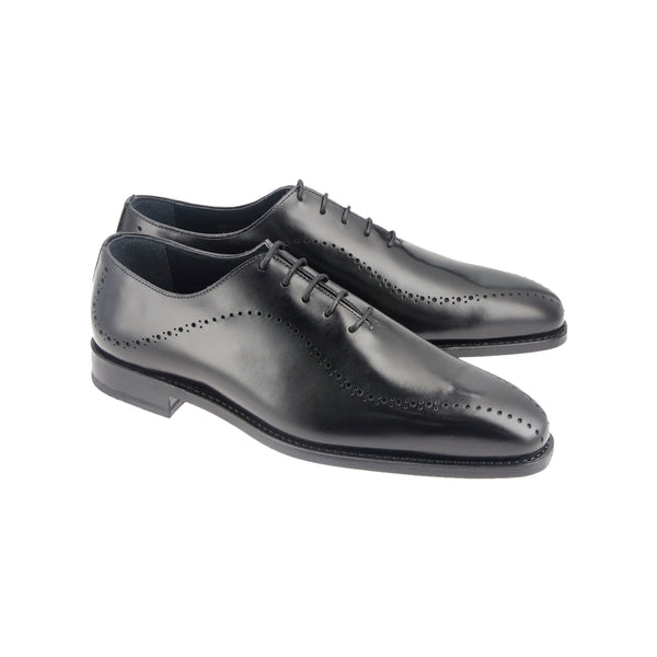 Black Oxford shoes with sleek brogue detailing in full-grain leather, Goodyear welted and handcrafted in Portugal on a soft chisel last.