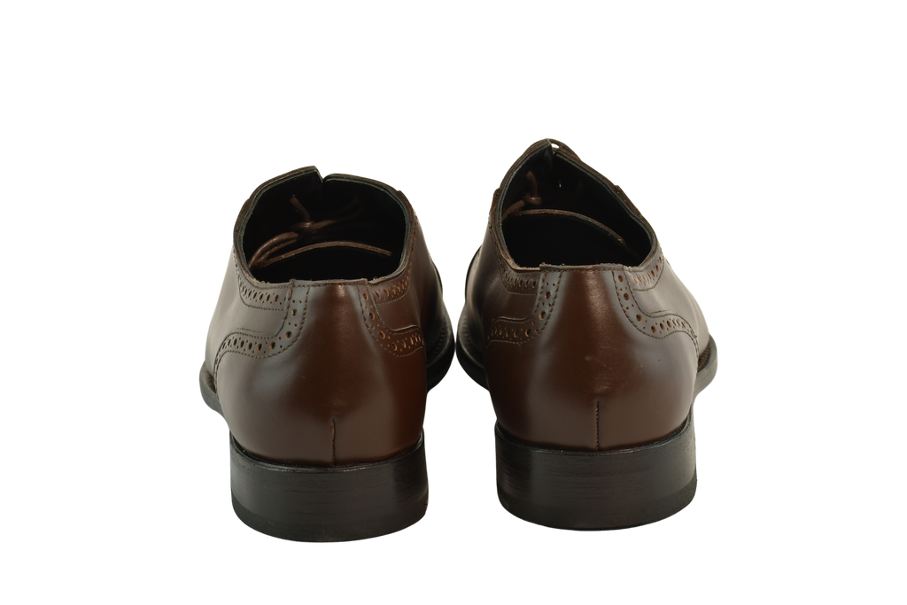 Chocolate brown Oxford shoes with brogue cap-toe design in full-grain leather, Goodyear welted and handcrafted in Portugal for classic elegance.