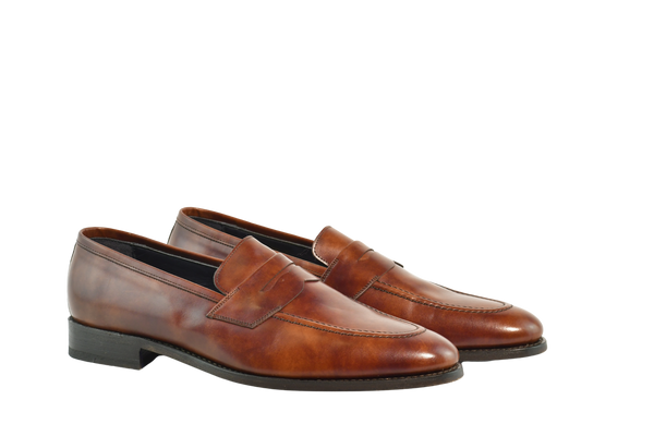 Museum Calf Bracklen penny loafers in rich reddish-brown leather, Goodyear welted and handcrafted in Portugal with round toe and blue soles.